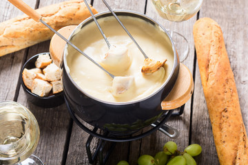 Cheese fondue with bread wine and grape