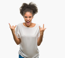 Young afro american woman over isolated background shouting with crazy expression doing rock symbol...