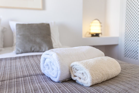 Towels for body and for hands on the bed.