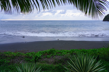 View of the black sand Lafayette beach in historic Matavai Bay near Papeete, French Polynesia