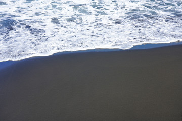 View of the black sand Lafayette beach in historic Matavai Bay near Papeete, French Polynesia