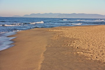 desolate blue sea. sandy beach and slightly rough sea. a clear winter's day.