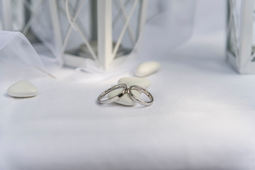 Close up of Wedding rings near comfits and wedding favors