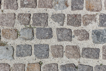 Seamless texture of old square stone pavement with big gaps between.