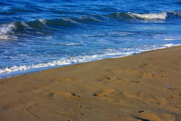 desolate blue sea. sandy beach and slightly rough sea. a clear winter's day.