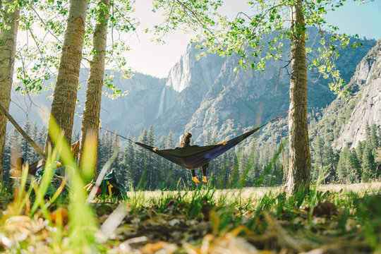 Rear view of woman relaxing in hammock at Yosemite National Park