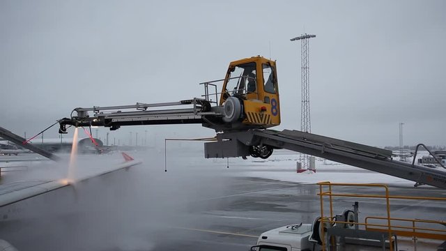 Oslo Gardermoen Airport (Norwegian: Oslo Lufthavn, OSL, ENGM) Norway, December 2018, aircraft wing deicing before departure during winter season