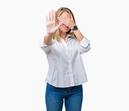 Beautiful young business woman over isolated background covering eyes with hands and doing stop gesture with sad and fear expression. Embarrassed and negative concept.