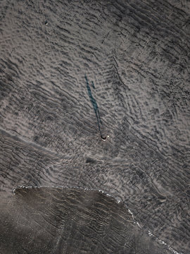 Aerial view of man playing soccer on sand at beach