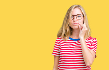 Beautiful young woman wearing glasses over isolated background mouth and lips shut as zip with...