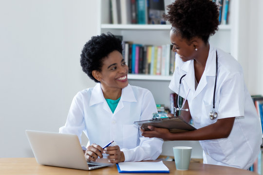 African american female doctor with young nurse