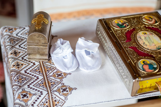 Holy Bible and Orthodox cross prepared for christening ceremony in church