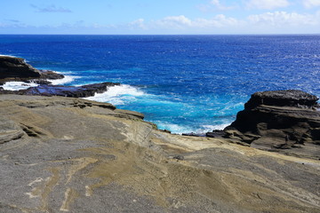 View of the Pacific Ocean crashing onto lava rocks at Hanauma Bay on the south-eastern shore of Oahu, Hawaii