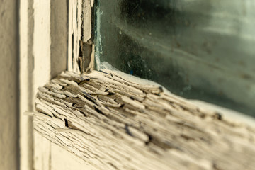 flaking paint of an old window