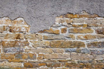 Mittelalterliche Steinmauer mit abfallendem Verputz als Hintergrund für Compositing
