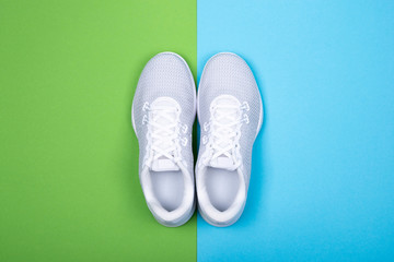 White sneakers on blue and green background. 