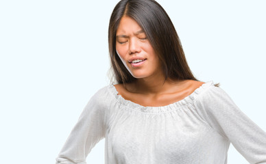 Young asian woman over isolated background with hand on stomach because indigestion, painful illness feeling unwell. Ache concept.