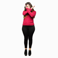 Fototapeta premium Young beautiful woman wearing red sweater Rejection expression crossing arms doing negative sign, angry face