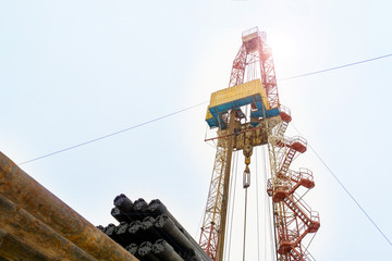 Oil and Gas Drilling Rig onshore dessert with dramatic cloudscape. Oil drilling rig operation on...