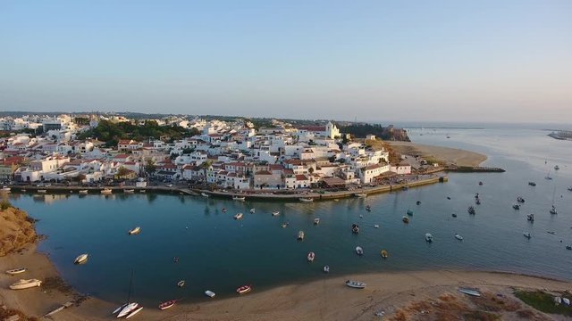 Aerial. Shooting from sky of Portuguese tourist city Ferragudo, view of the dock and beaches.
