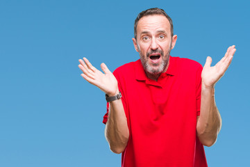 Middle age hoary senior man over isolated background clueless and confused expression with arms and...