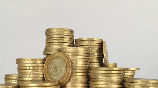 Mexican Golden Coins rotating over white background
