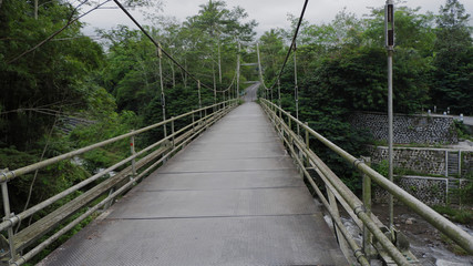 the road, on the suspension bridge