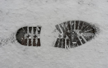 footprint in the snow - trace of a shoe sole