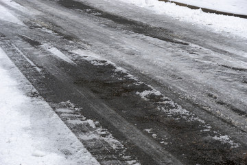 tire tracks in the snow on a iced road