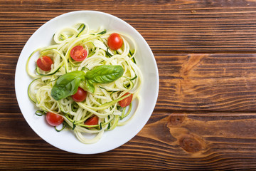 Zucchini pasta noodles with tomatoes . Healthy vegetarian food