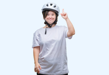 Young adult cyclist woman with down syndrome wearing safety helmet over isolated background pointing finger up with successful idea. Exited and happy. Number one.