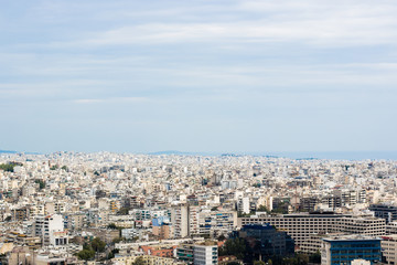 aerial city photography of Athens - capital of Greece with many white apartment buildings to horizon in summer bright clear weather time
