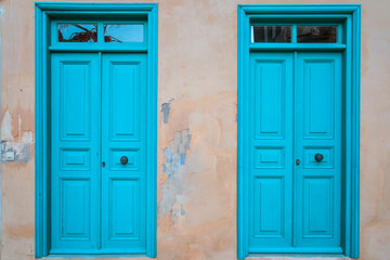 blue wooden vintage doors and old house wall.