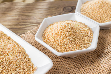 amaranth beans in bowl, on rustic wooden background