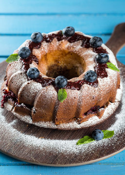 Homemade bundt cake with icing sugar and blueberry