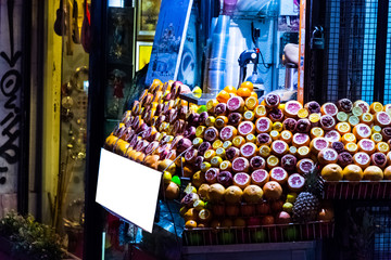 Fototapeta na wymiar Different kinds of fruits on the street table ready to make juic