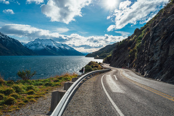 Long winding road called the Devil's Staircase leading to a snow capped mountain in New Zealand