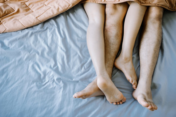 Asian couple in the bedroom on holiday morning.