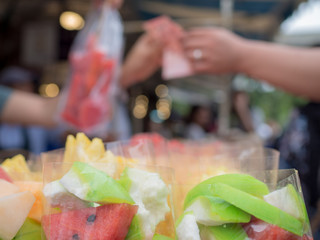 Watermelon, cantaloupe, guava, pineapple and other fruits for sell cut in piece in a plastic bag pack on the street at thailand