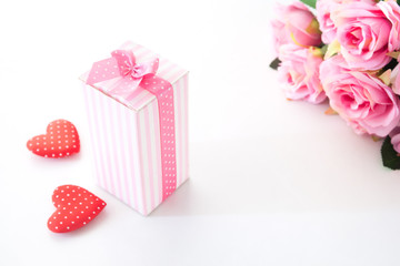 Close up gift box on white background with pink rose and heart on white background