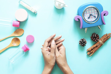 Top view of woman's hands with cosmetic containers, Beauty, skincare and lifestyle concept