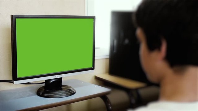 Blurred Boy Watching Monitor with Green Screen. You can replace green screen with the footage or picture you want with “Keying” effect in AE  (check out tutorials on YouTube).
