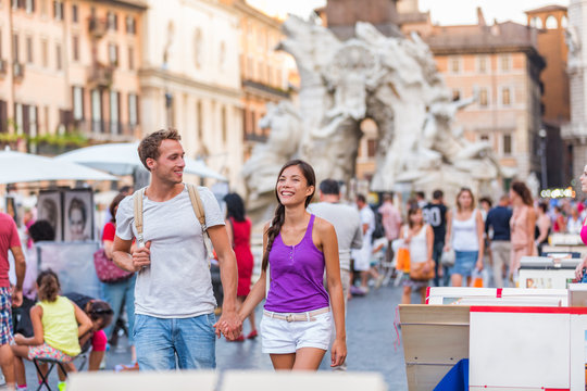 Fototapeta Europe travel tourists couple walking in Rome, Italy, on Piazza Navona, famous tourism attraction. Street city lifestyle, summer holidays. People relaxing enjoying life.