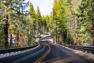 Travelling on a winding road on the shoreline of Lake Tahoe on a winter day