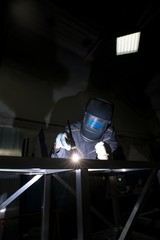 View of man in face shield doing argon welding