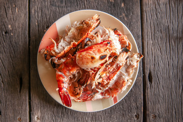 Food waste shrimp shells in plate on old wood table