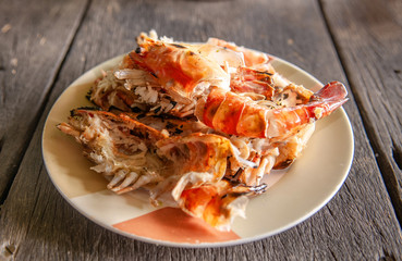 Food waste shrimp shells in plate on old wood table