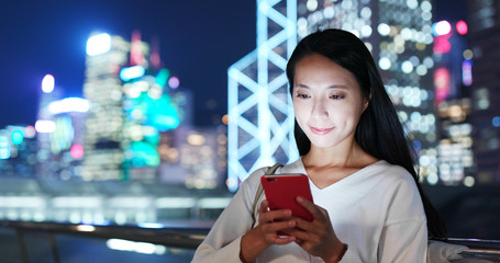 Businesswoman use of mobile phone at night
