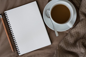 Top view of Note Book with Coffee on bed,