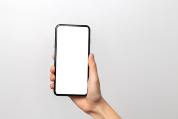 Hand woman holding smartphone with blank screen isolated on white background with clipping path